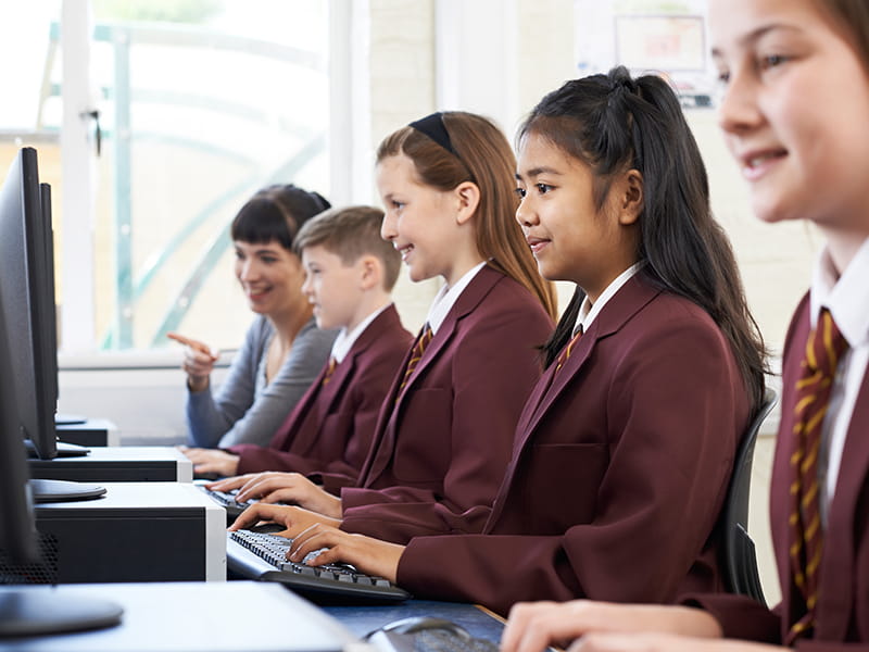 A line of private school students in a computer lesson